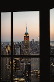 Evening cityscape viewed from a high-rise office window.