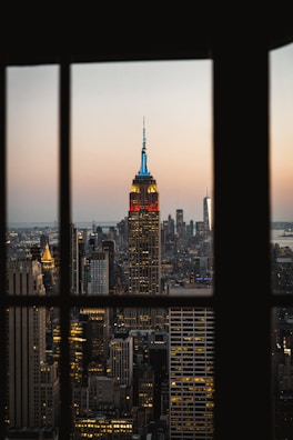Evening cityscape viewed from a high-rise office window.