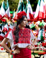 a woman standing in front of a display of flags
