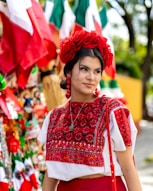 a woman wearing a red skirt and a red flower in her hair