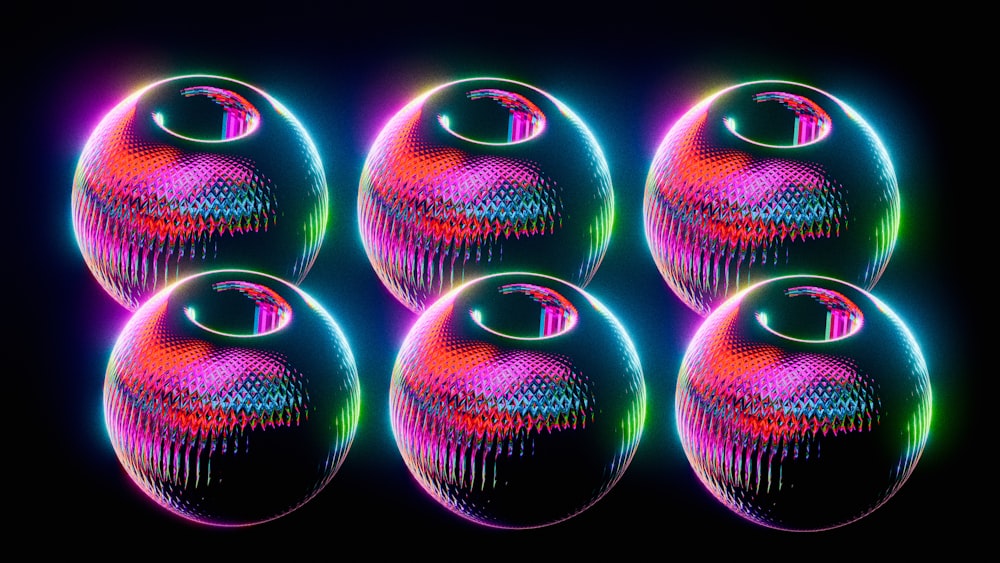 a group of balls with different colors on a black background