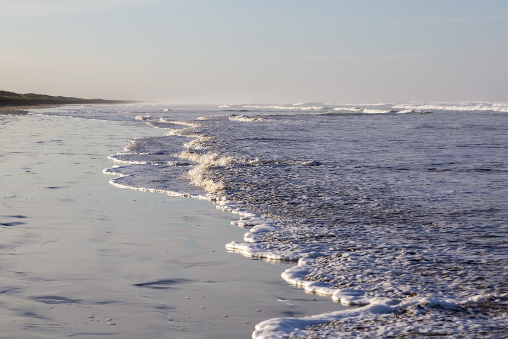 a beach with waves coming in to shore