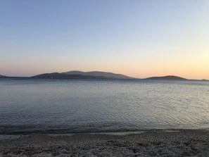 A serene sunset over a quiet beach, capturing the calm after a day of adventure.
