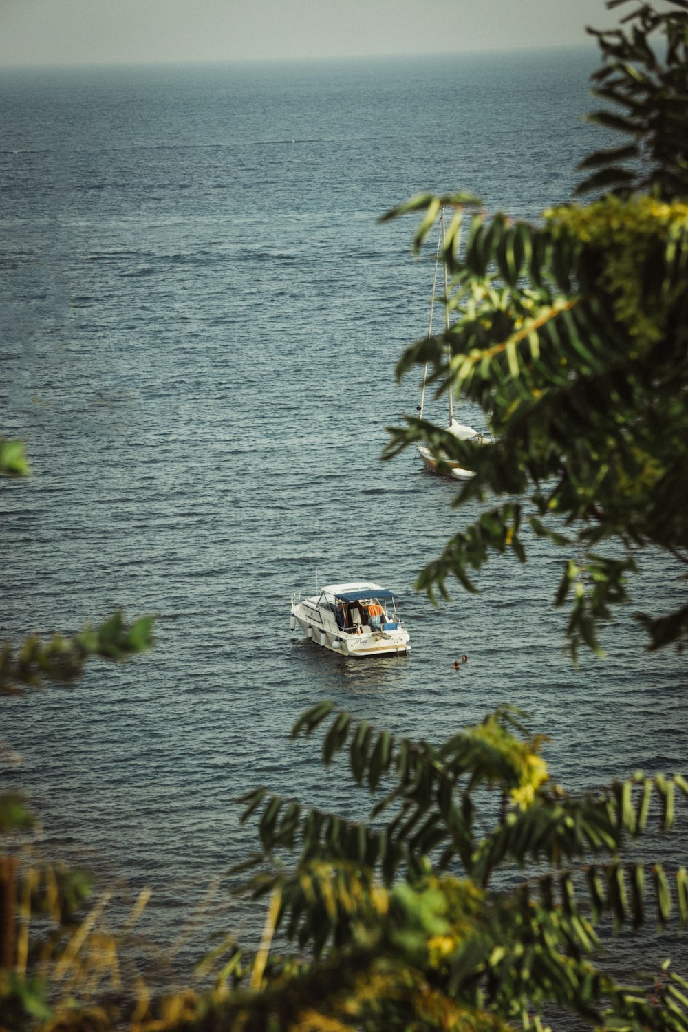 a small boat floating on top of a large body of water