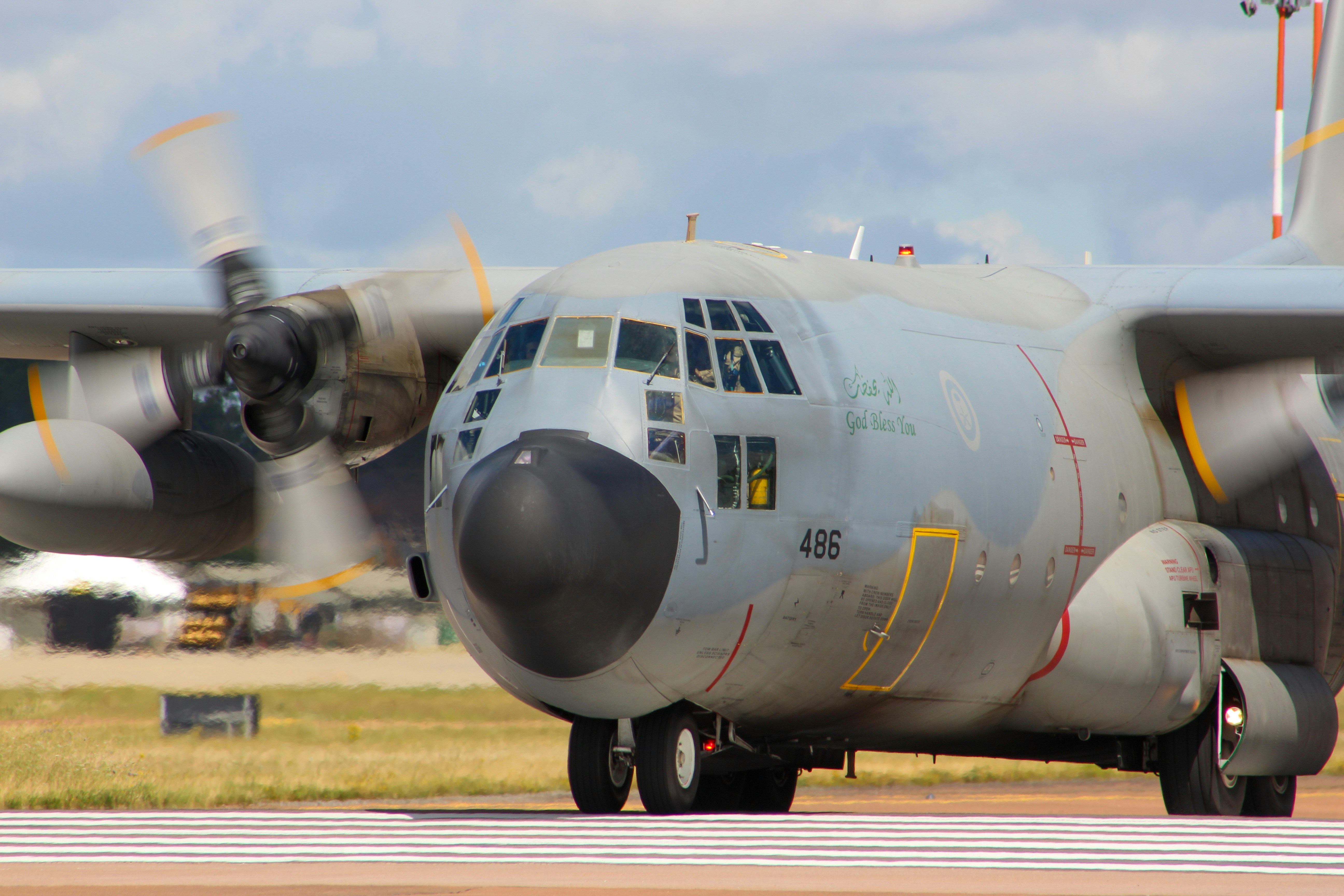 a large propeller plane sitting on top of an airport runway, 