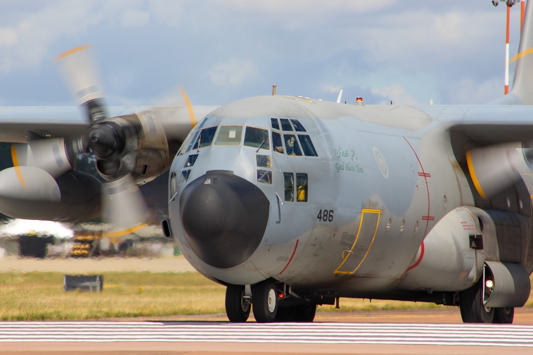 a large propeller plane sitting on top of an airport runway,