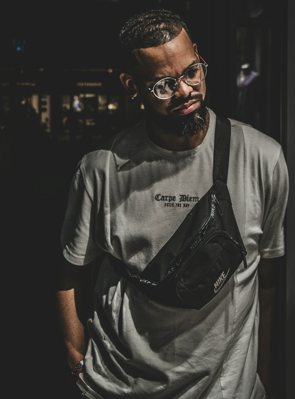 a man with a beard and glasses wearing a fanny bag
