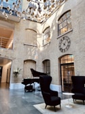 a large room with a piano and a clock on the wall