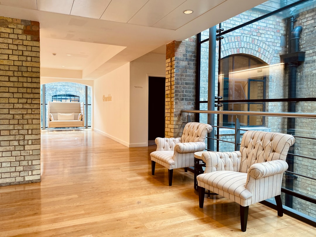 a row of chairs sitting on top of a hard wood floor, from Bumble London office