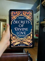 A digital tablet showing a relationship advice ebook, with two hands gently holding a heart-shaped object.