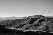 Panoramic view of rolling hills and terraced gardens under a warm afternoon light.