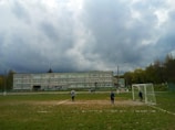 Students enjoying a spirited football match on the school playground under clear skies