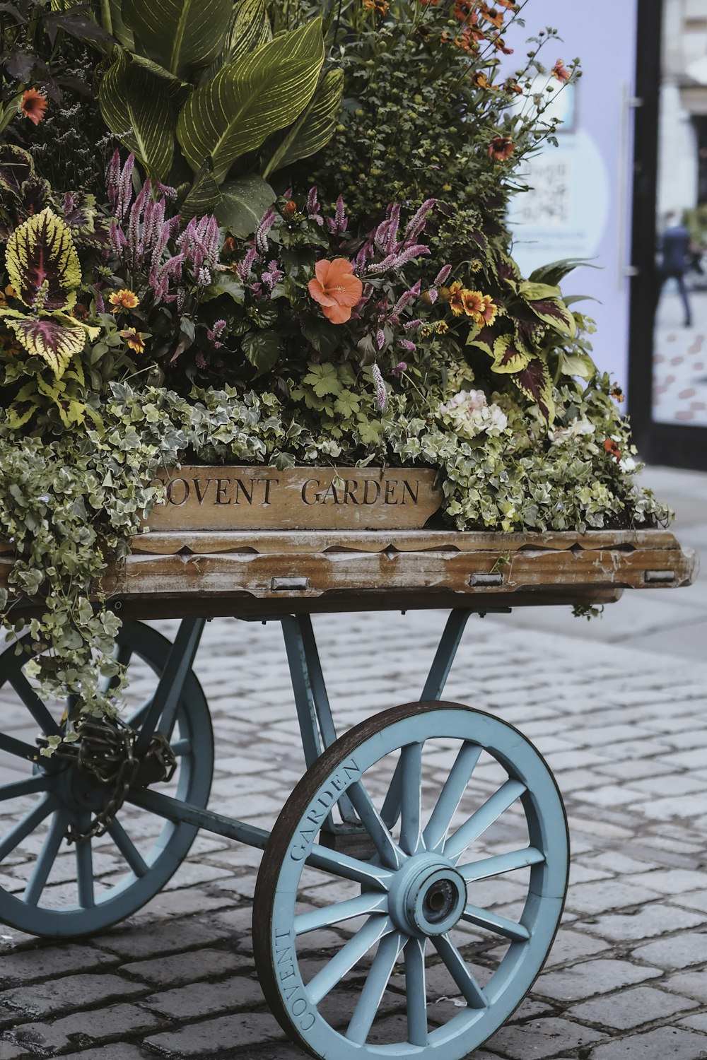 a wooden wagon filled with lots of flowers