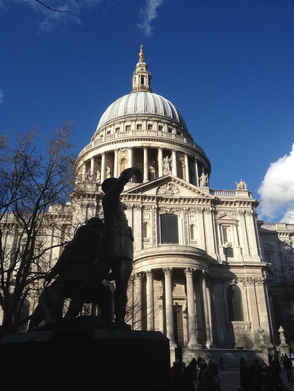 a statue of a goat in front of a building