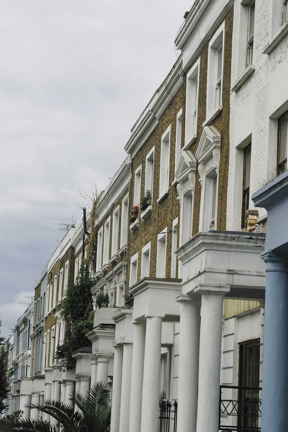 a row of white buildings with columns and windows