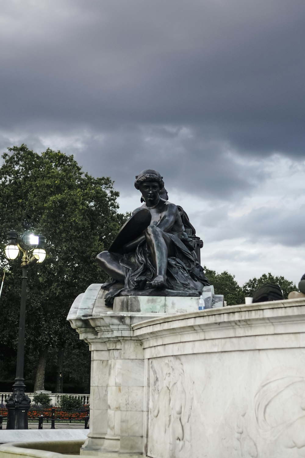 a statue of a woman sitting on top of a bench