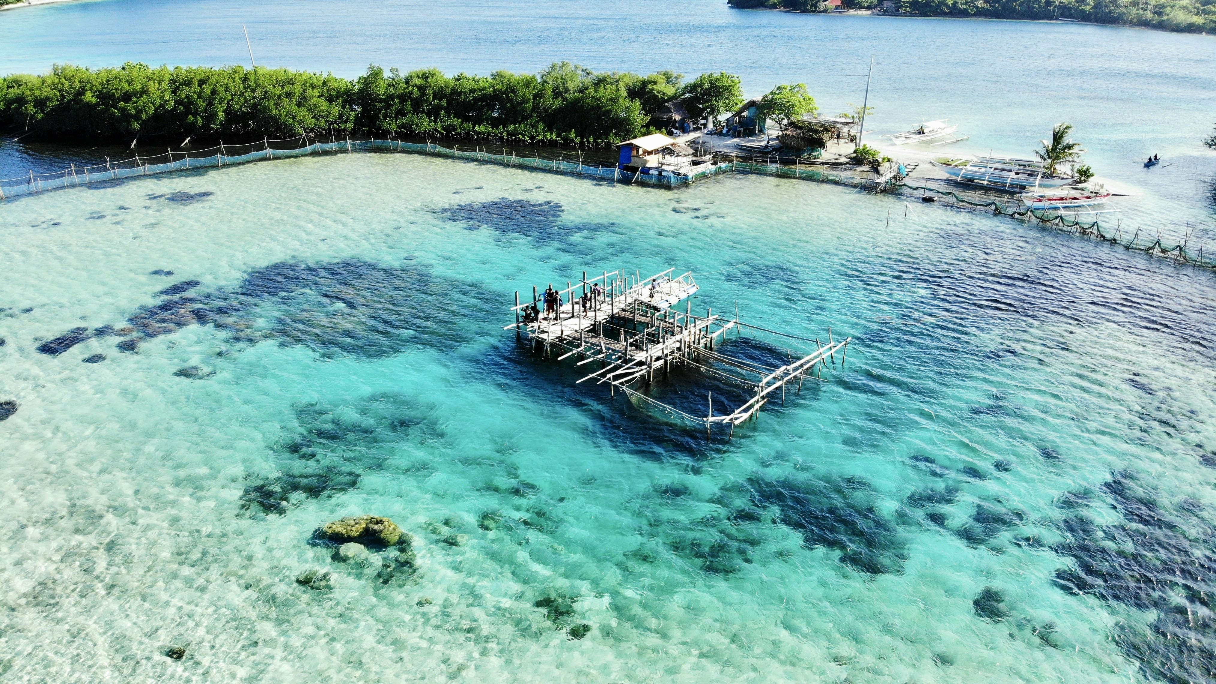 an aerial view of a dock in the water, Drone shot of a Fishery in Palawan