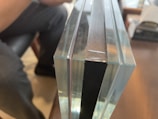 Close-up of protective padding being applied to a fragile glass table.