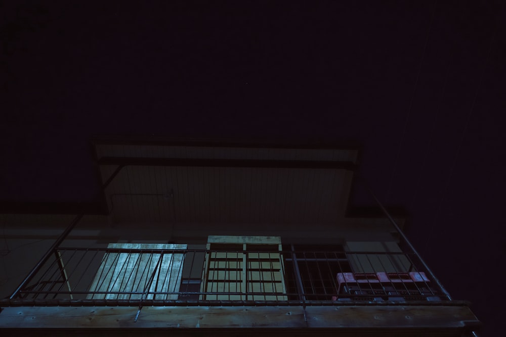 a building with a balcony at night time