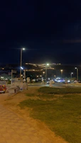 Nighttime shot of a completed road section illuminated by soft street lighting, emphasizing quality.