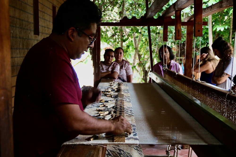 a group of people sitting at a long table