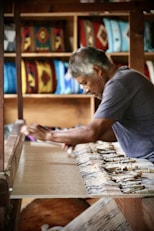 a man is working on a piece of wood