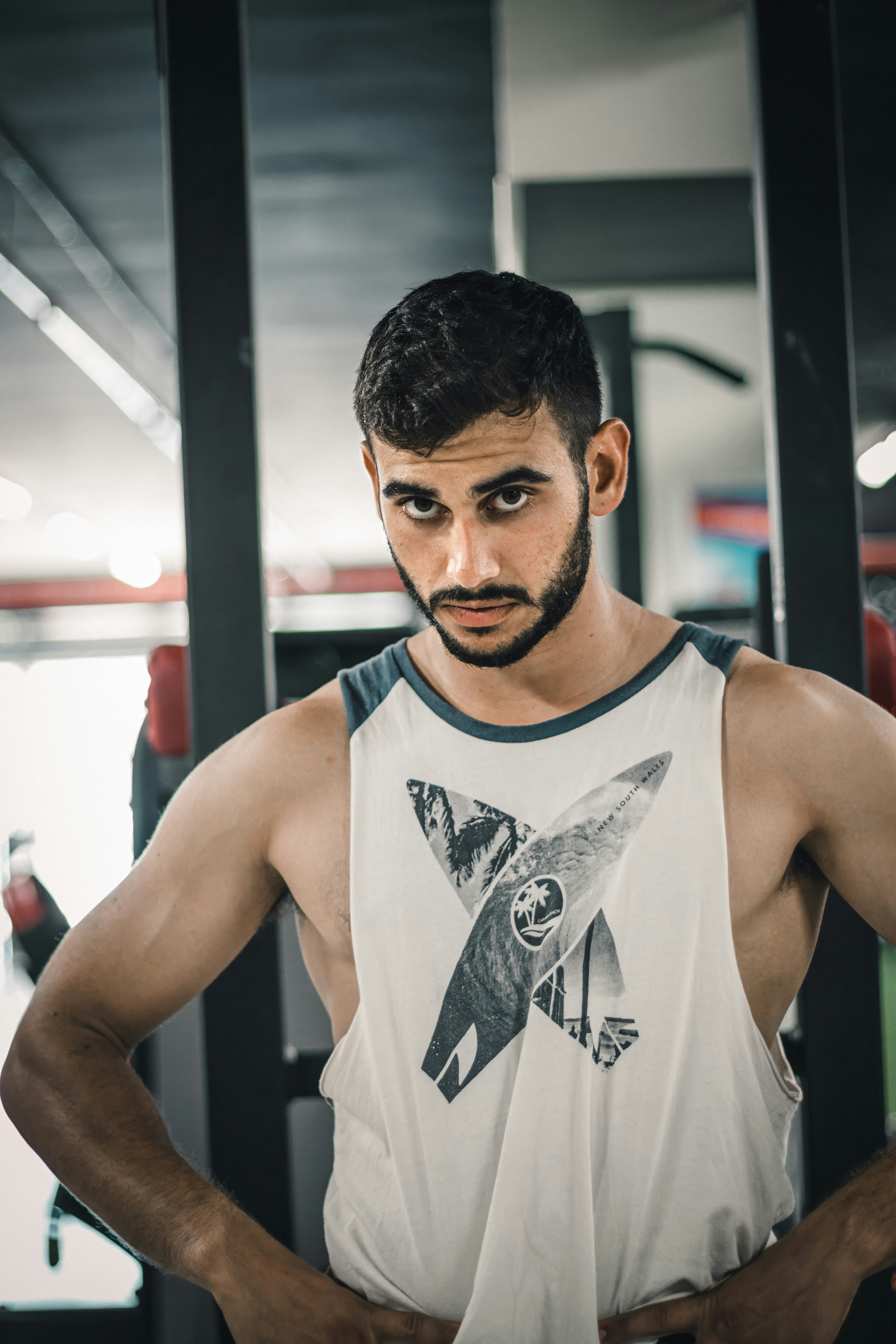 A man standing in a gym with his hands on his hips photo – Free Pose ...