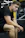 A focused young man lifting heavy weights in a sleek, black and gold gym setting.