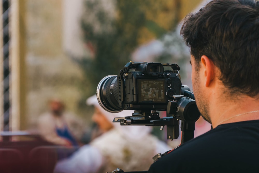 a man holding a camera up to take a picture