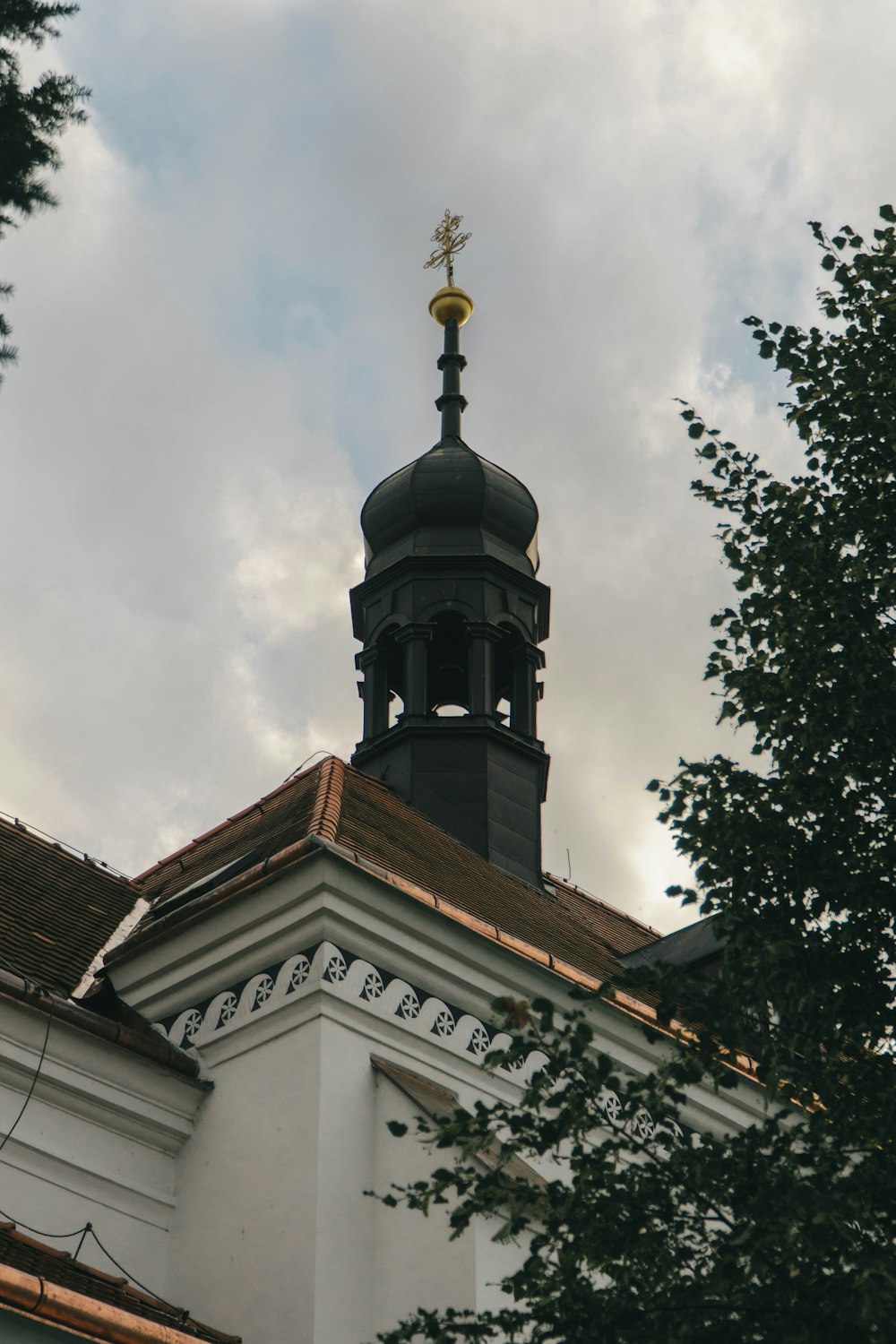 a building with a steeple and a cross on top