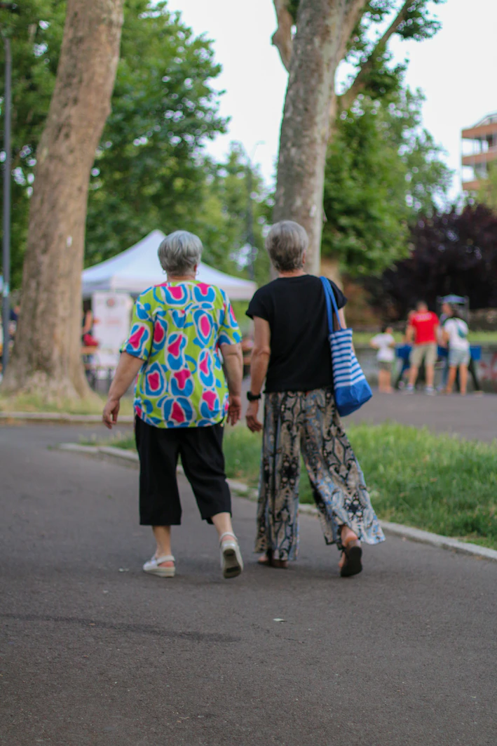 a couple of people walking down a street