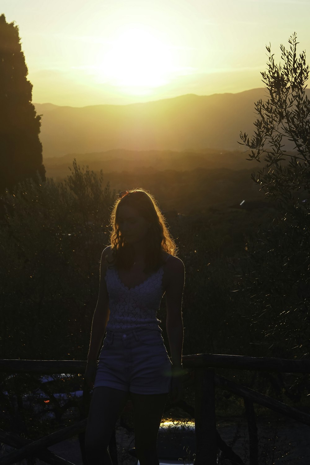 a woman standing on top of a wooden bench