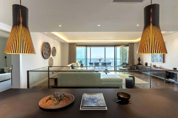 a living room with a couch a table and some lights