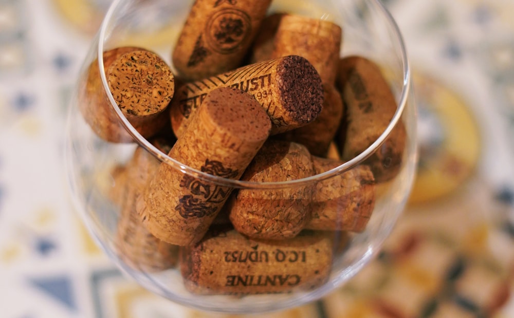 a glass filled with lots of wine corks