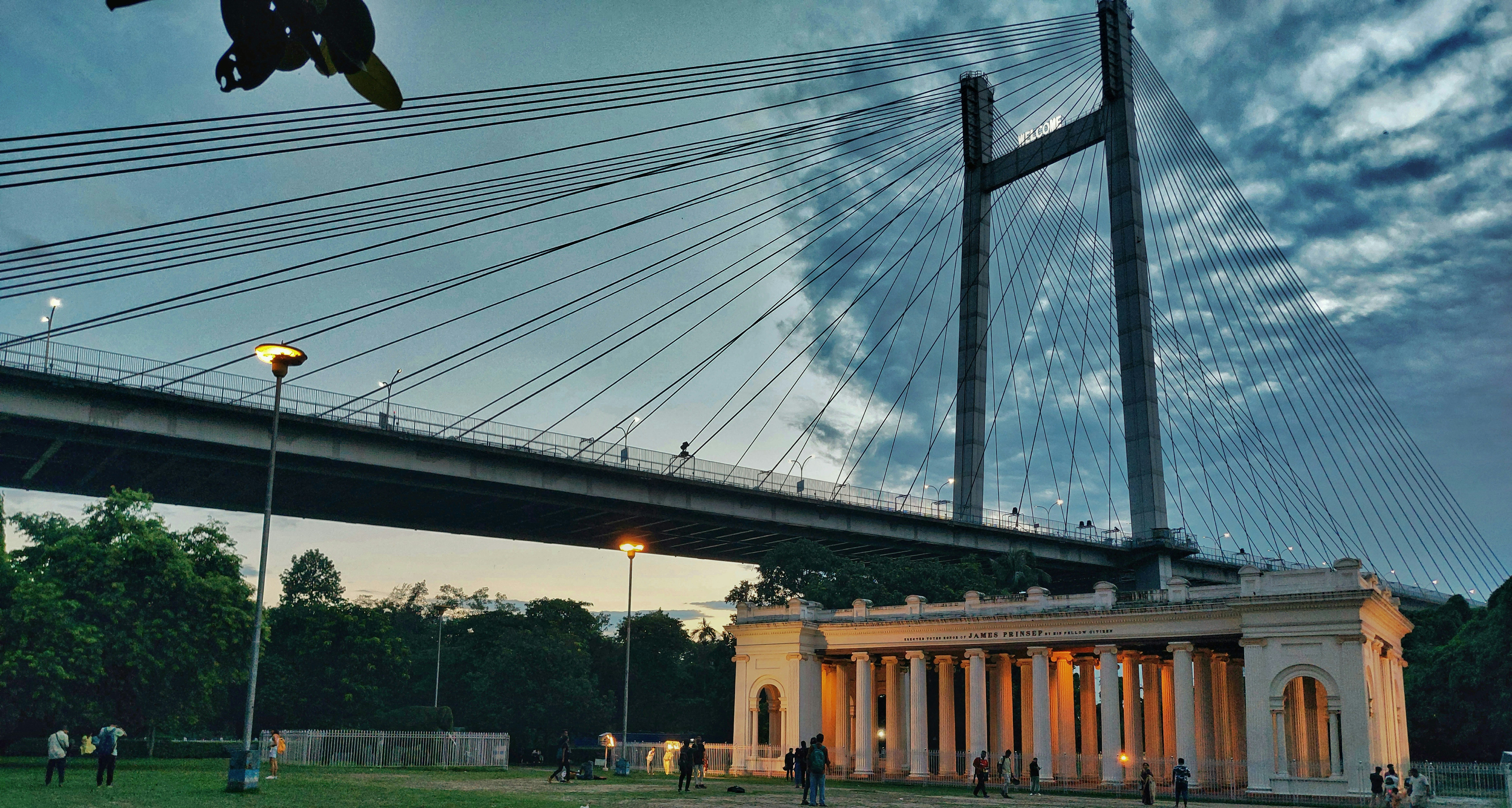 A bridge over a body of water at dusk photo – Free Kolkata Image on ...
