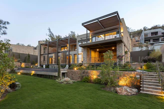 a house with a lot of windows and lights on it