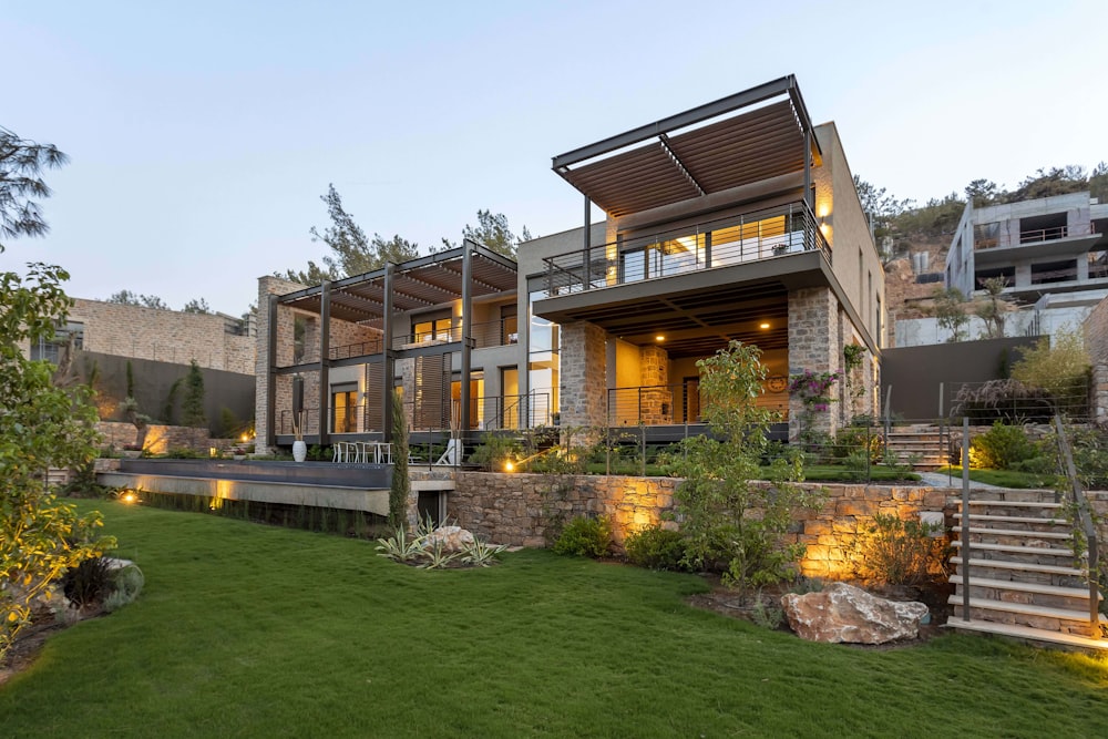 a house with a lot of windows and lights on it