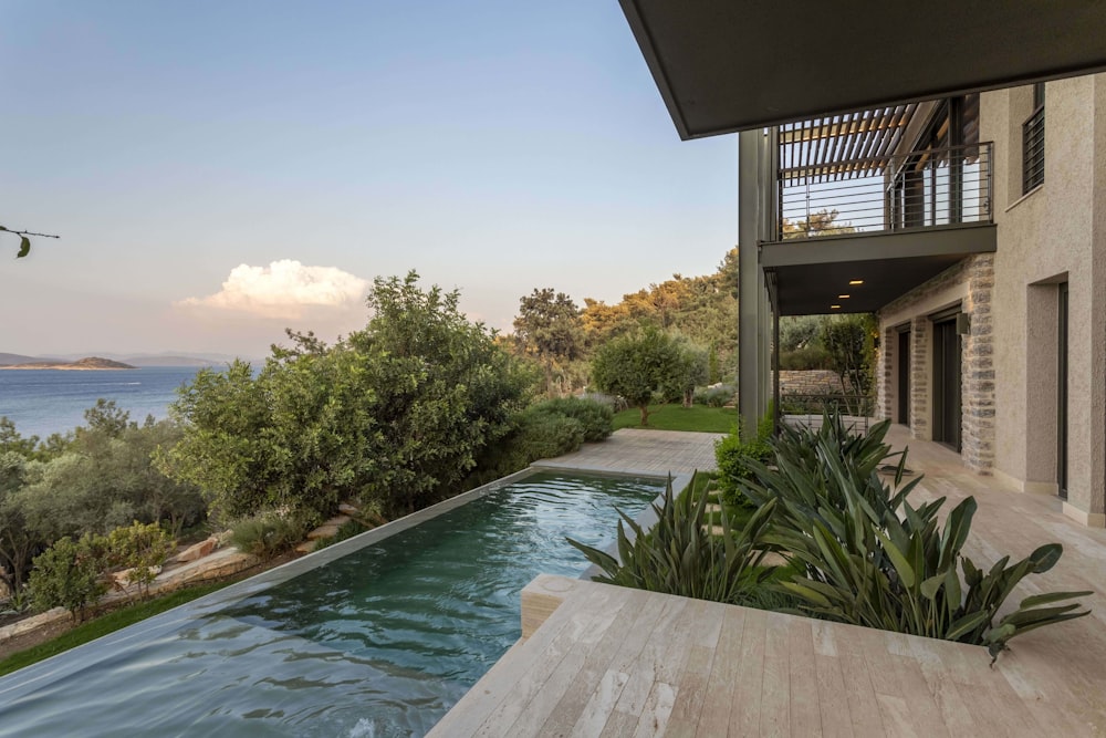 a house with a swimming pool in front of it