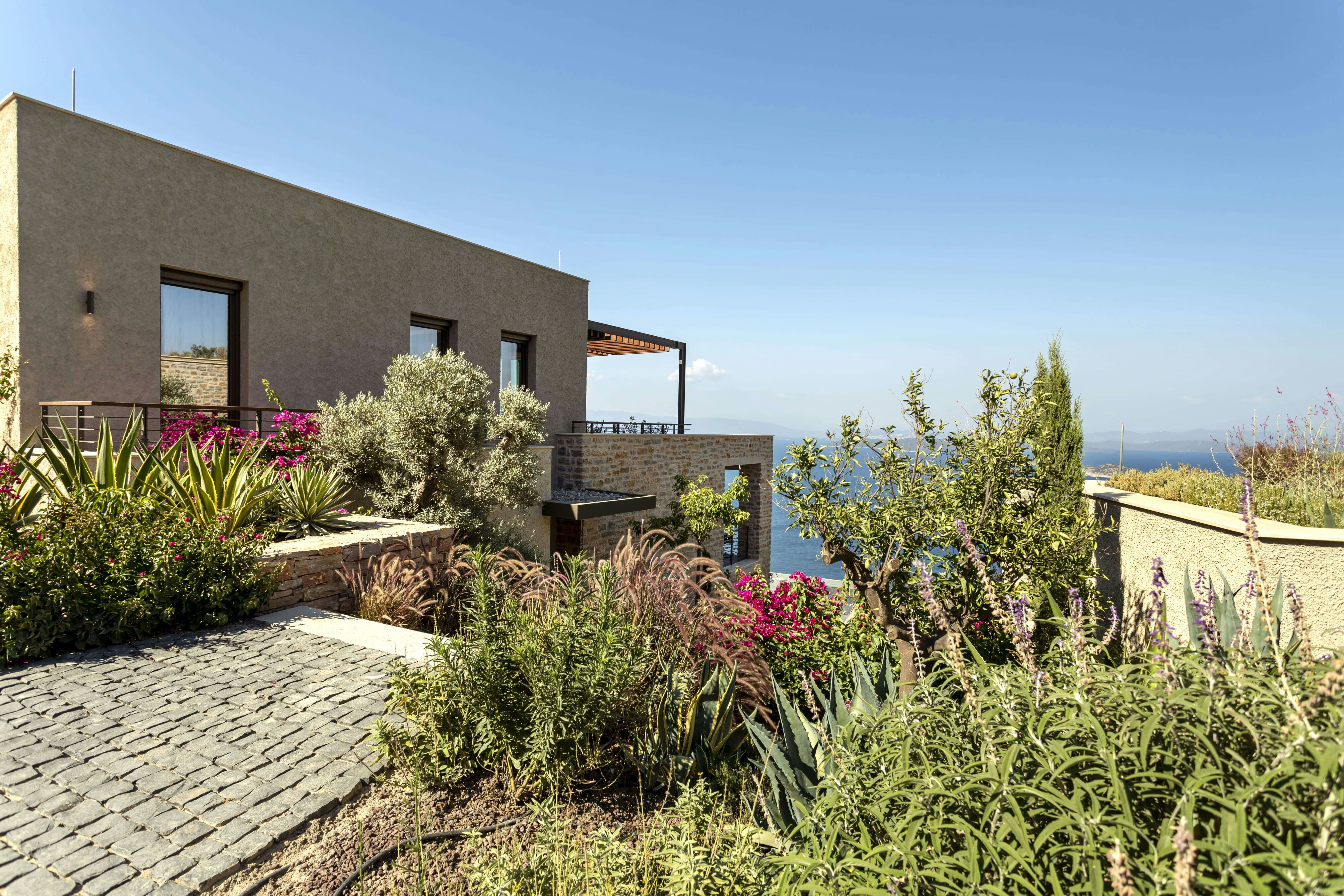 a house on a hill overlooking a body of water