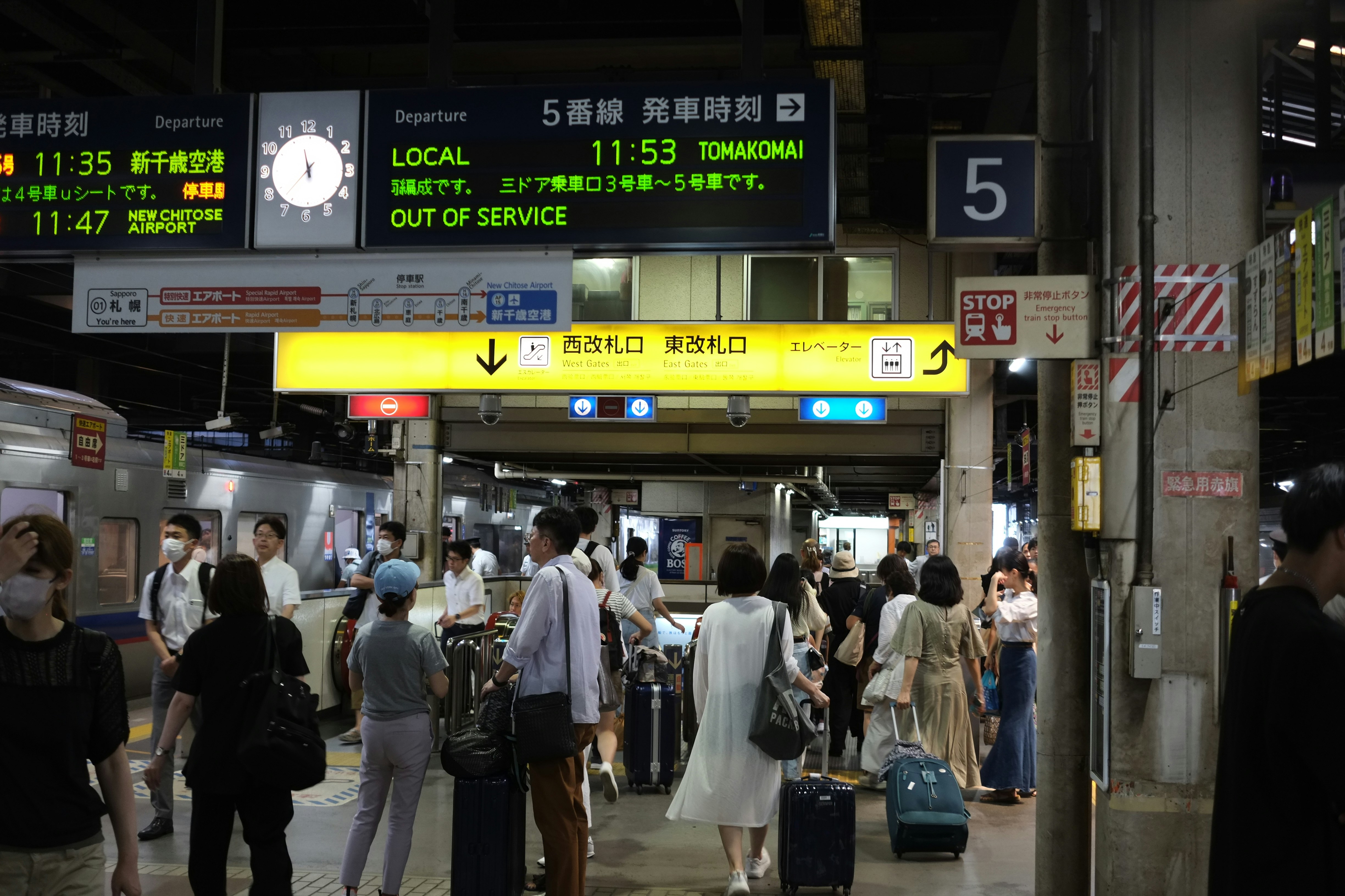 a group of people standing around a train station
