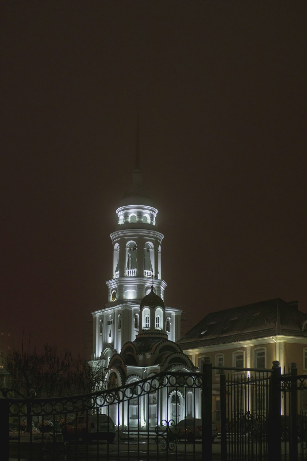 a large building with a clock tower lit up at night