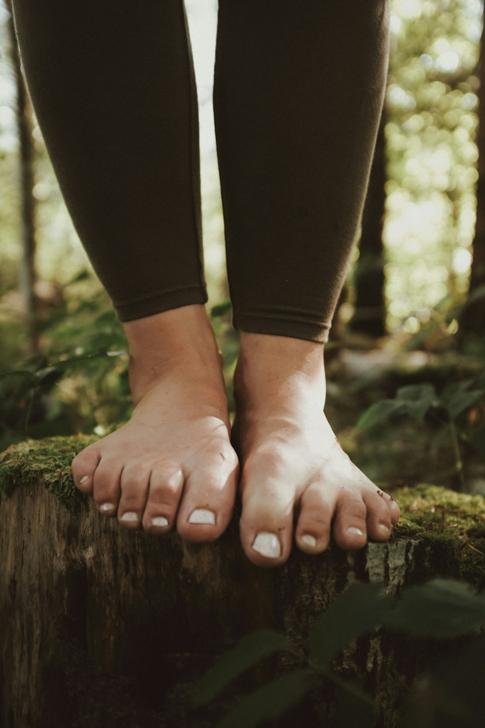 a person standing on a log in the woods