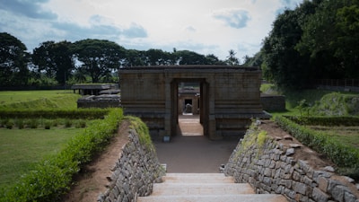 An ancient stone structure surrounded by lush greenery.