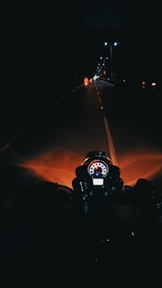 A motorcycle equipped with Prosense halogen lamps shining dynamically during a night ride.