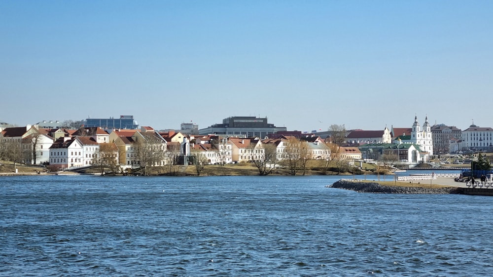 a body of water with buildings in the background