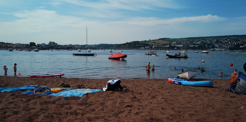 a group of people standing on top of a sandy beach