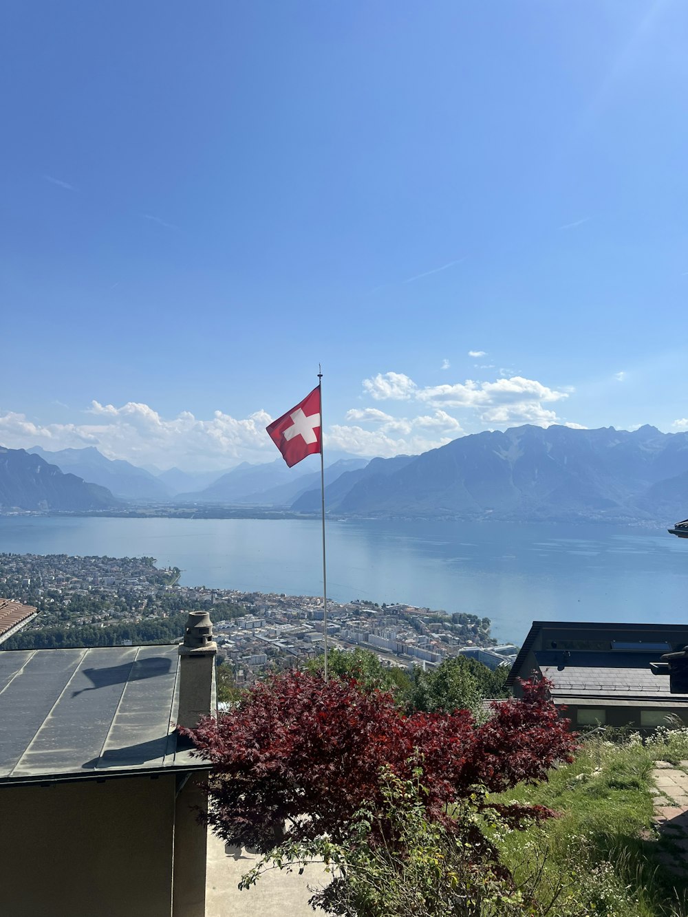 a flag flying on top of a building next to a lake