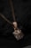 A close-up of a beautifully engraved pendant showcasing detailed artwork and soft lines.