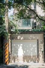 Close-up of a garage door spring being lubricated