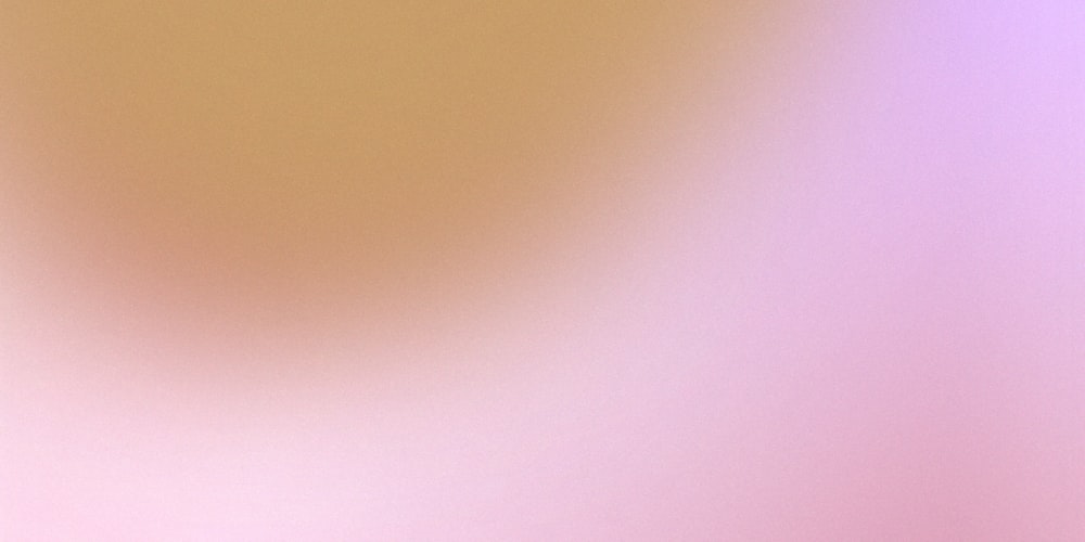 a blurry image of an orange and pink background